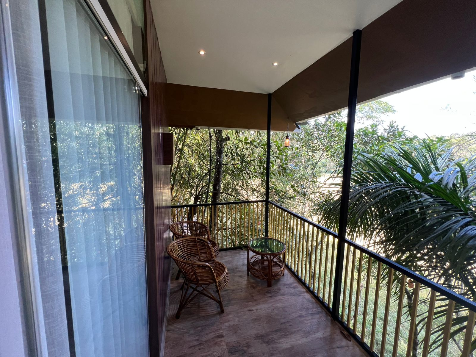 Bamboo-railed balcony with forest view